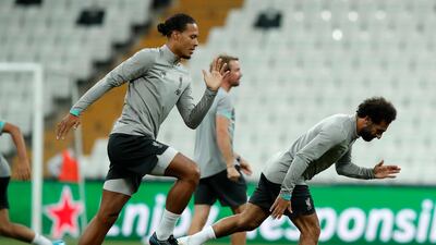Van Dijk and Salah run during a training session. AP Photo
