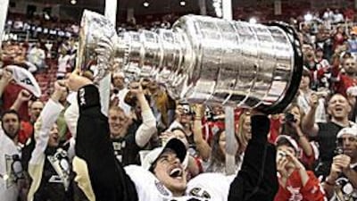 A jubilant Sidney Crosby raises the Stanley Cup after his Pittsburgh Penguins beat the Detroit Red Wings 2-1 in the seventh game of the finals in Detroit.