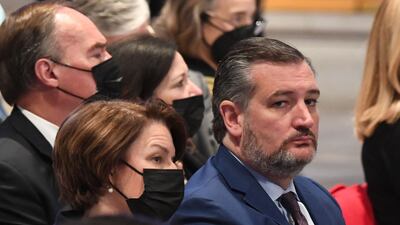 US senators Ted Cruz and Amy Klobuchar attend the funeral service. Mr Cruz was the only attendee not wearing a mask. AFP