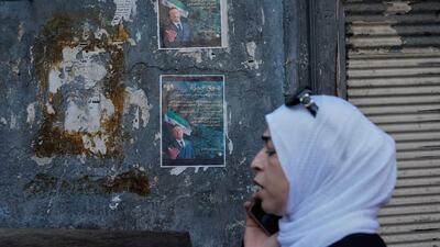 A Syrian passes posters showing Syrian-American Jewish candidate Henry Hamra, a candidate for Sunday's parliamentary elections, in the Jewish neighbourhood of old Damascus on October 3. AP