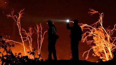 Firefighters keep watch on the Thomas wildfire in the hills and canyons outside Montecito, California, US. Gene Blevins / Reuters