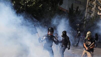 Protesters are seen shrouded in tear gas during clashes outside the court in Athens. Reuters