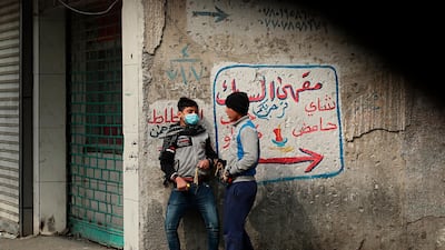 Protesters prepare to use slingshots to fire a stone at security forces during clashes in Baghdad, Iraq. AP Photo