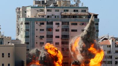 FILE PHOTO: An explosion is near a tower housing AP, Al Jazeera offices during Israeli missile strikes in Gaza city, May 15. Reuters