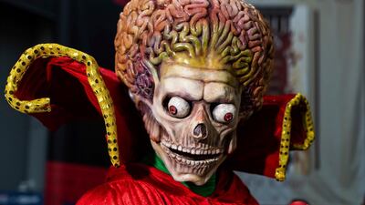 An attendee dressed as a Martian from 'Mars Attacks!' poses during New York Comic Con. AP