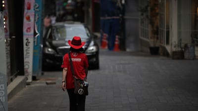 A tour guide walks on an empty street in the central district of Myeongdong in Seoul, South Korea. EPA