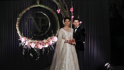 Newlyweds Priyanka Chopra, 36, and Nick Jonas, 26, pose for a photograph during a reception at a hotel in New Delhi on December 4, 2018. Photo: EPA