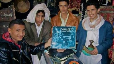 Young men holding vintage records in a shop in Yemen. Chris Menist was struck by the helpfulness of people in Sanaa and Aden, once they understood what he was looking for.