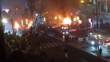 A grab from video footage posted on social media on January 9, 2026, shows cars set on fire during a protest at Saadat Abad Square in Tehran. AFP