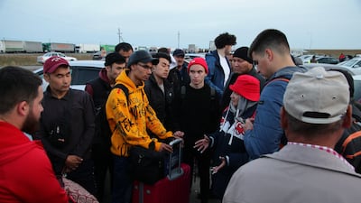 Russians are helped by a volunteer upon arrival in Kazakhstan last week. AFP