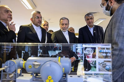 Iran’s Foreign Minister Abbas Araghchi, centre, views an exhibition of the country's nuclear achievements at the Atomic Energy Organisation in Tehran on Monday. Atomic Energy Organisation of Iran / AFP
