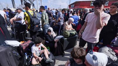 Palestinians, some with foreign passports hoping to cross into Egypt, waiting for aid at the Rafah crossing in the southern Gaza Strip. AFP