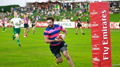 UR7’s (pink and blue) v O’Neills Nomads (black) during Day 1 of the Emirates Airlines Dubai Rugby Sevens at The Sevens in Dubai on Thursday. Victor Besa for The National