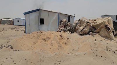 This frame grab taken from AFPTV video footage on August 7, 2026, shows the damage at Mail al-Saila internally displaced camp (IDP) on the outskirts of Marib following a reported Houthi ballistic missile attack on the government-held city of Marib early August 7, amid an escalation in hostilities. The strategic province of Marib is split between the Houthis and the government, which controls the city of Marib as well as the surrounding oil fields and facilities. (Photo by AFPTV / AFP) /