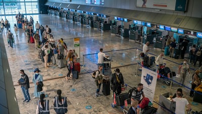 Passengers check in at the Lufthansa counter at Johannesburg's O R Tambo Airport. AP