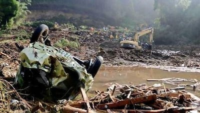 Rescue workers search for missing people at the scene of a landslide in Aso, Kumamoto prefecture, Japan.
