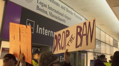People gather for a protest at the international arrivals of Boston's Logan International Airport. John Cetrino / EPA