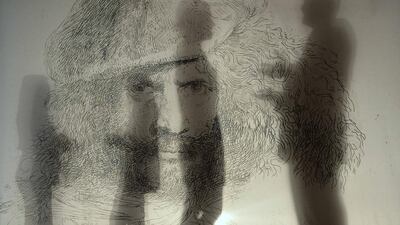 Visitors are seen behind a promotional print of a self portrait of the 17th century Italian artist Castiglione at The Queen's Gallery in Buckingham Palace, London. Toby Melville / Reuters