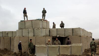 Afghan security forces stand guard at an army outpost after an attack by Taliban militants in Kunduz province. AFP