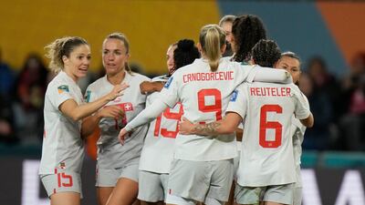 Switzerland players hug after a goal by Seraina Piubel. AP Photo