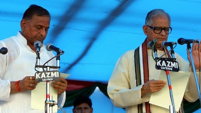 Yadav, left, takes the oath of office during his swearing-in ceremony in Lucknow, India, in August 2003. EPA
