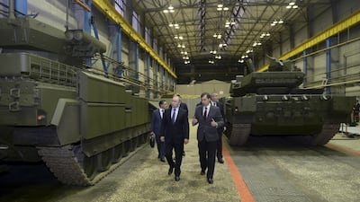 Russian President Vladimir Putin (L) listens to Andrei Terlikov, the head of the Ural Transport Machine Building Design Bureau, as they inspect a Russian infantry fighting vehicle. Alexei Nikolskyi / Via Reuters