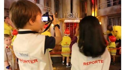 Youngsters at KidZania discover what it's like to be a photographer or reporter for The National. Courtesy Abu Dhabi Media