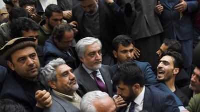 Afghan presidential election opposition candidate Abdullah Abdullah (C) arrives to give a press conference after the announcement of the final presidential elections results at the Sapedar Palace in Kabul on February 18, 2020. Afghan presidential election loser Abdullah Abdullah on February 18 contested final results that declared his rival Ashraf Ghani the winner of last year's poll, vowing he would form his own parallel government. Afghan election officials said final results showed he had won 39.52 percent of last September's vote, while Ghani had taken 50.64 percent. / AFP / WAKIL KOHSAR