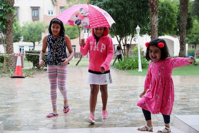 Children enjoy a rainy day in Al Furjan community near Jebel Ali, Dubai. Pawan Singh / The National