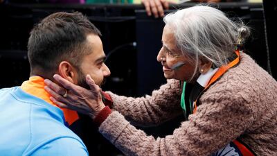 India's Virat Kohli meets India fan, Charulata Patel, at the end of the match. Action Images via Reuters