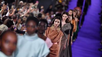 Amira Al Zuhair, in the centre wearing a satin bias-cut dress, on the Alexis Mabille runway. AFP