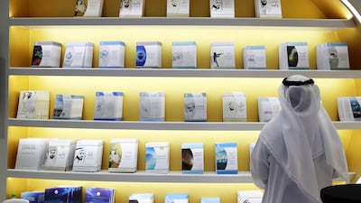 A visitor on the first day of the Abu Dhabi Book Fair. Last year, more than 152,000 people visited the event at which over 165,000 books were sold. Pawan Singh / The National