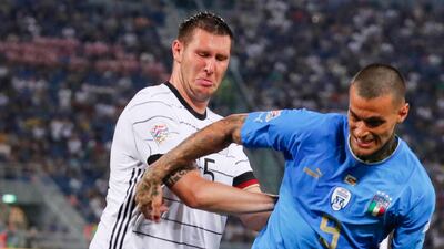 Italy's Gianluca Scamacca is challenged by Germany's Niklas Suele in their Nations League match. EPA