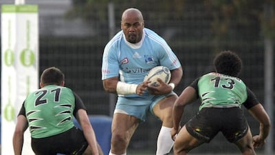 Jonah Lomu, centre, runs with the ball as Montmelian’s Sylvain Maulet, left, and Kevin Zhakata try to stop him during their Federale One match between Marseille-Vitrolles and Montmelian in Vitrolles, southern France. Claude Paris / AP Photo