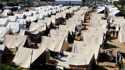 Palestinians, who fled their houses amid Israeli strikes, in a tent camp in Khan Younis, southern Gaza Strip. Reuters