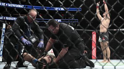 Vicente Luque, right, celebrates after knocking out Belal Muhammed during a welterweight mixed martial arts bout. Julio Cortez / AP Photo