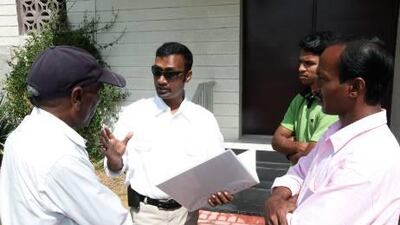 n:Imran Choudhury, centre, talks to Bangladeshi workers about his new association to help and support his countrymen living in Dubai.