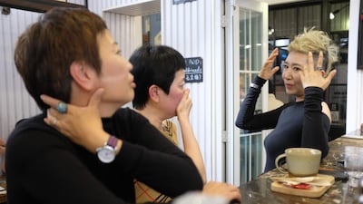 The 56-year-old Chinese model Ma Yinhong, right, talking to her friends at a cafe in central Shanghai. AFP