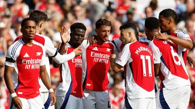 Arsenal's Bukayo Saka, third left, celebrates scoring. EPA