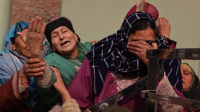 Relatives of Mohammad Shafi Parry, a civilian worker who died in an accidental explosion at Nowgam Police Station, wait for his body at his home on the outskirts of Srinagar, the summer capital of Indian Kashmir. EPA