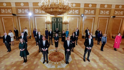 Dutch King Willem-Alexander, centre right, and Prime Minister Mark Rutte, centre left, with most of the new government at Noordeinde Palace in the Hague, the Netherlands, on Monday. AP