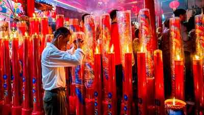 A Chinese-Indonesian man prays on the eve of the Lunar New Year in Surabaya, East Java province. Juni Kriswanto / AFP Photo
