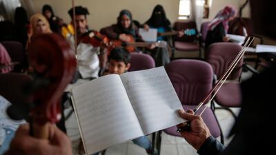 Abdullah El-Deb'y teaches his students during a music class at the Cultural Centre in Sanaa, Yemen. Hani Mohammed / AP Photo