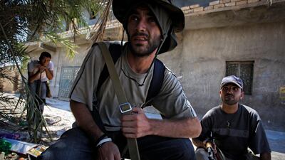 Rebel fighters look towards the enemy as they hear the sound of bombardments in the village of Mayah, some 30 kilometers west from Tripoli, LIbya, Sunday, Aug. 21, 2011. Libyan rebels said they were less than 20 miles (30 kilometers) from Moammar Gadhafi???