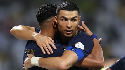 Al Nassr's Cristiano Ronaldo congratulates Abdulelah Al Amri after his goal during the Saudi Pro League match against Al Wehda. AFP