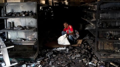 A man looks to for goods amid the rubble of a burnt market in Ciudad Bolivar, Venezuela. Manaure Quintero / AFP Photo