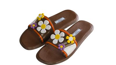 Prada upscales beach slides with leather and oversized plastic daisies. Courtesy Prada