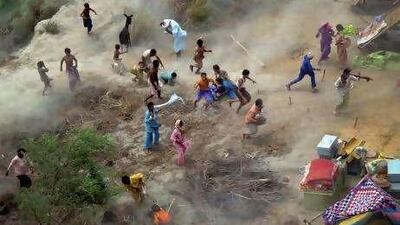 Pakistani villagers chase down relief supplies downed from an army helicopter in a flood-hit area of Mithan Kot, in central Pakistan.