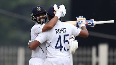 Rohit Sharma (R) celebrates his century with team-mate Ajinkya Rahane during the first day of the third and final Test match between India and South Africa. AFP