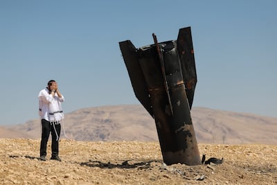 An Ultra-Orthodox Jew is shocked at the sight of Iranian ballistic missile stuck in the ground in a field near the settlement of Mevo'ot Yericho in the occupied West Bank. EPA